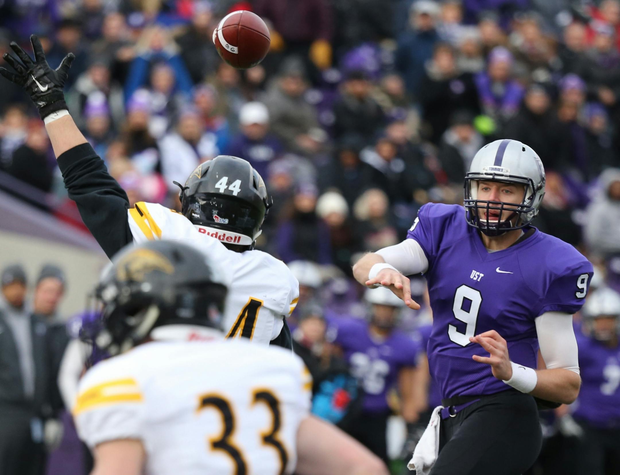 St. Thomas quarterback Alex Fenske (9) fires a 4-yard touchdown strike to tight end Matt Christenson, not pictured, during the first quarter of NCAA Div. III playoff action Saturday in St. Paul.