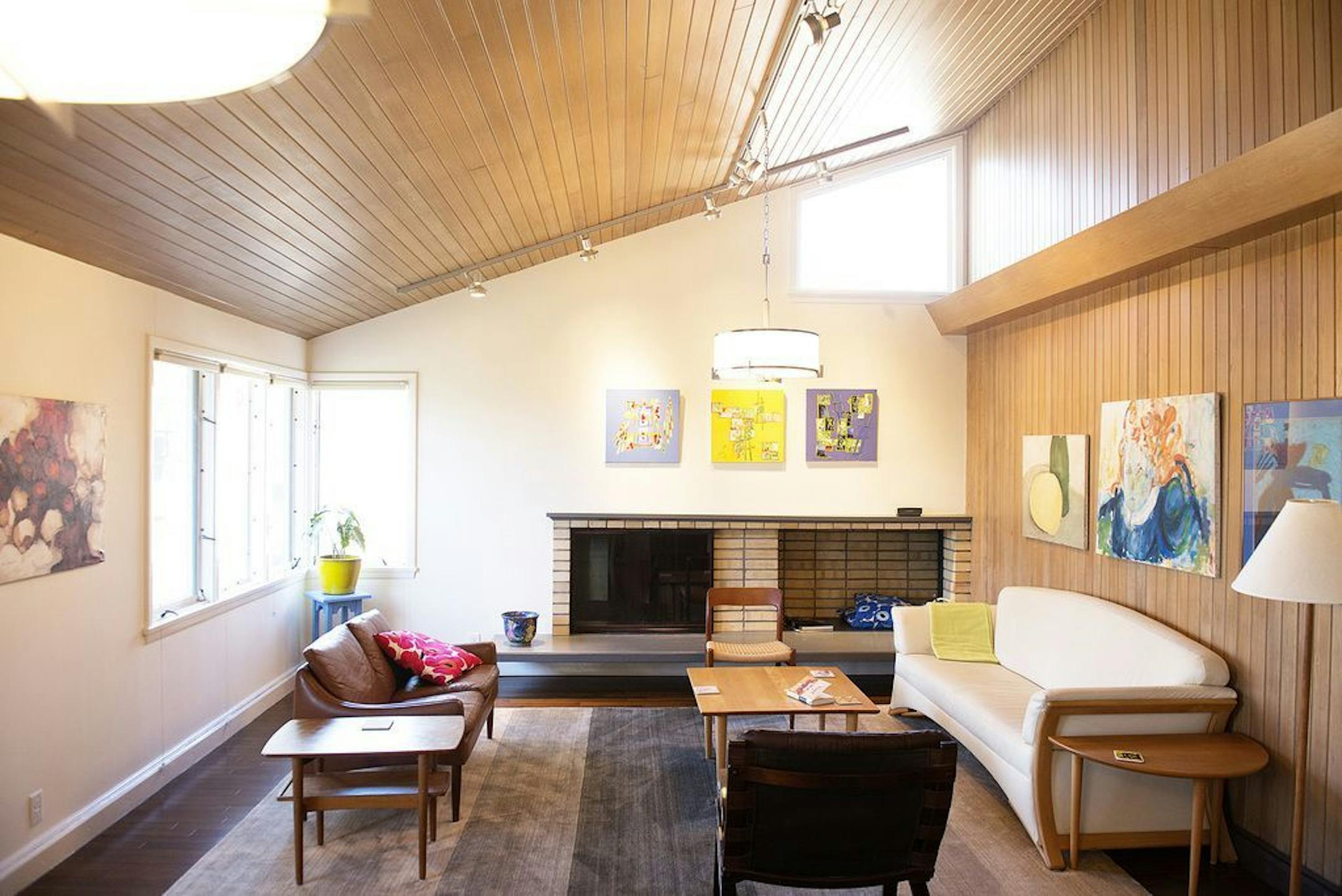 Renovations on this midcentury gem included knocking down a wall between the kitchen and living room, adding more lighting and restoring the cedar paneling.