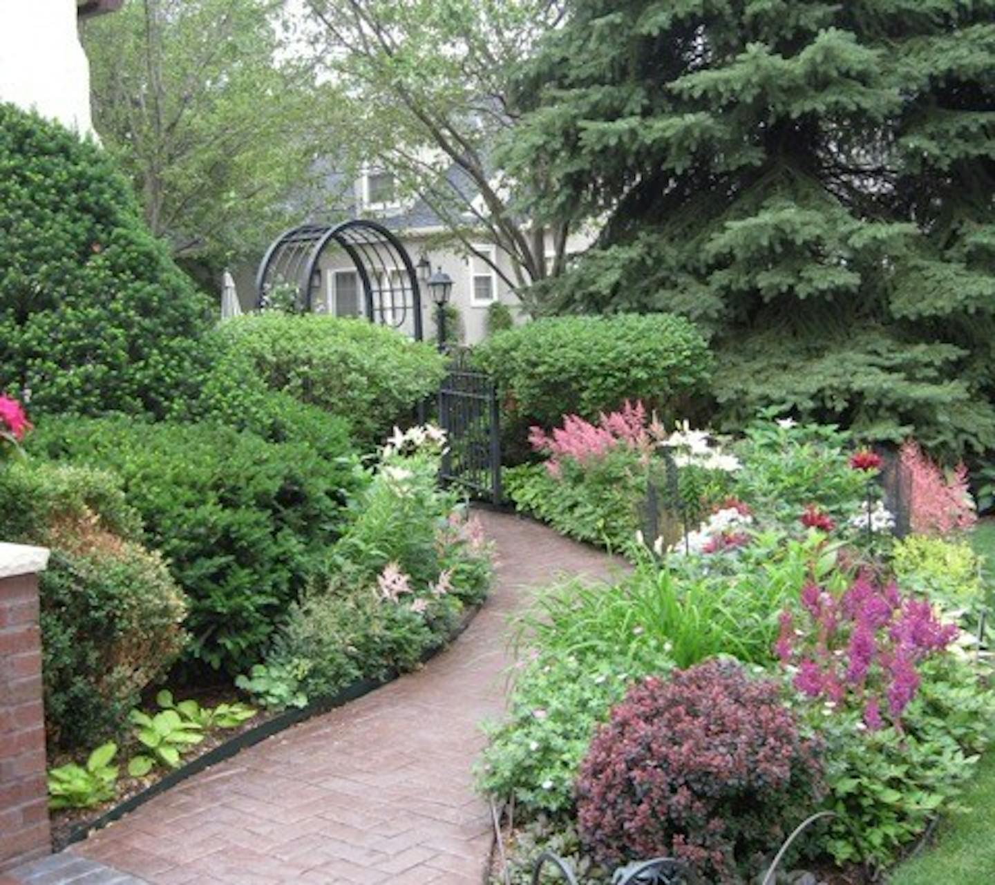 Kathy Freeman has created a pocket paradise around the Tudor cottage she shares with her husband, Bill, in St. Paul's Highland Park.