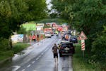 Firefighters vehicles and emergency vehicles on the site of the collision of a bus with a train near the town of Nove Zamky, Slovakia, Thursday, June 