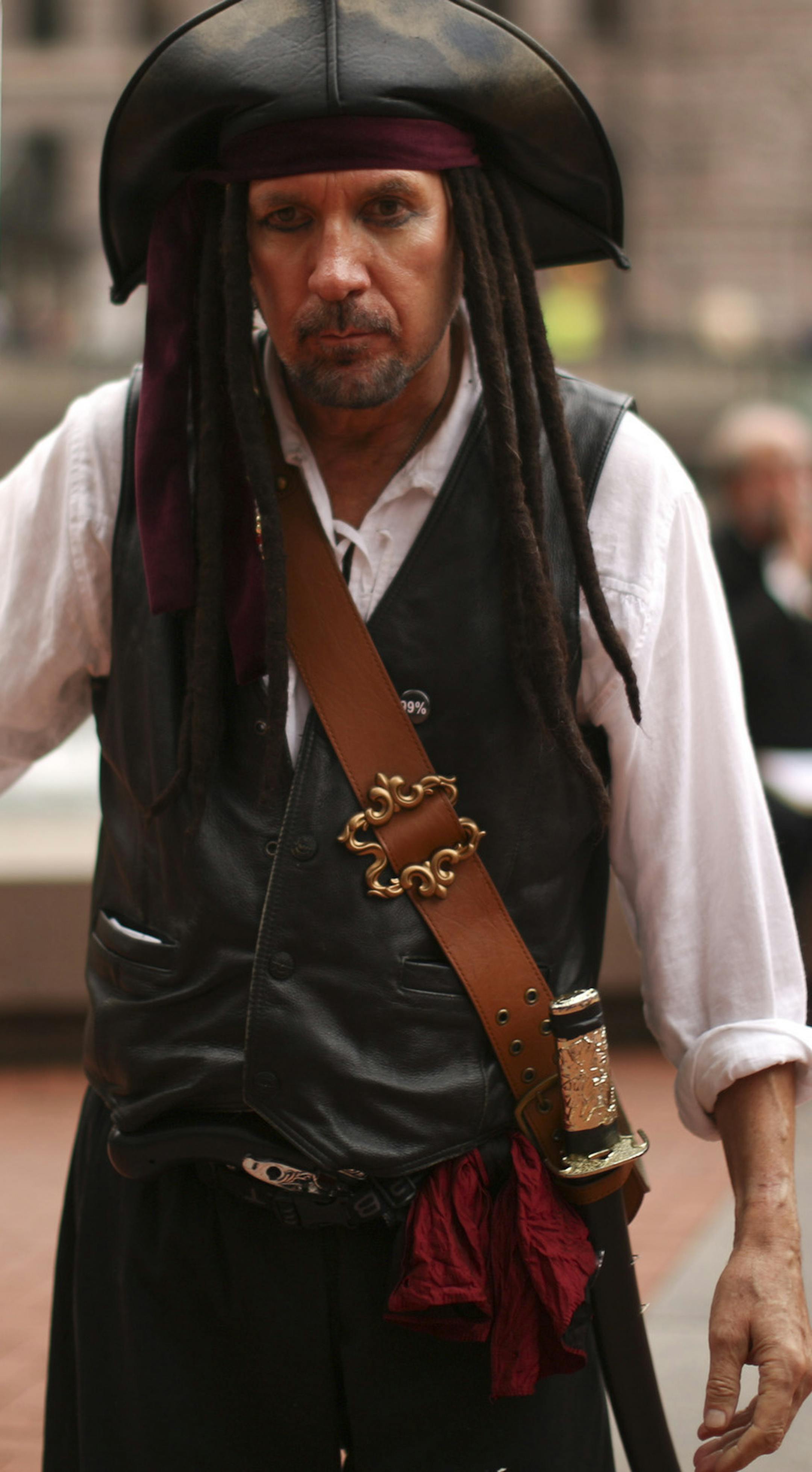 There are so many minor party candidates vying for the job of Minneapolis Mayor that several of them have banded together to form a "Mayoral Council" that meets weekly to advance their causes. The council met for the sixth time Wednesday afternoon, September 18, 2013 at Government Plaza across from City Hall in Minneapolis. Captain Jack Sparrow held up a poster for a proposal he has put forward for community ownership of an NFL football team. In this example, the Green Bay Packers would be share