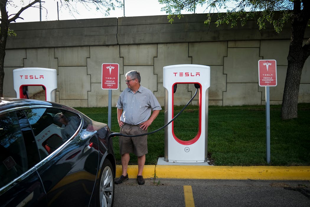A man charged his Tesla outside of a Target in St. Louis Park in June 2021.