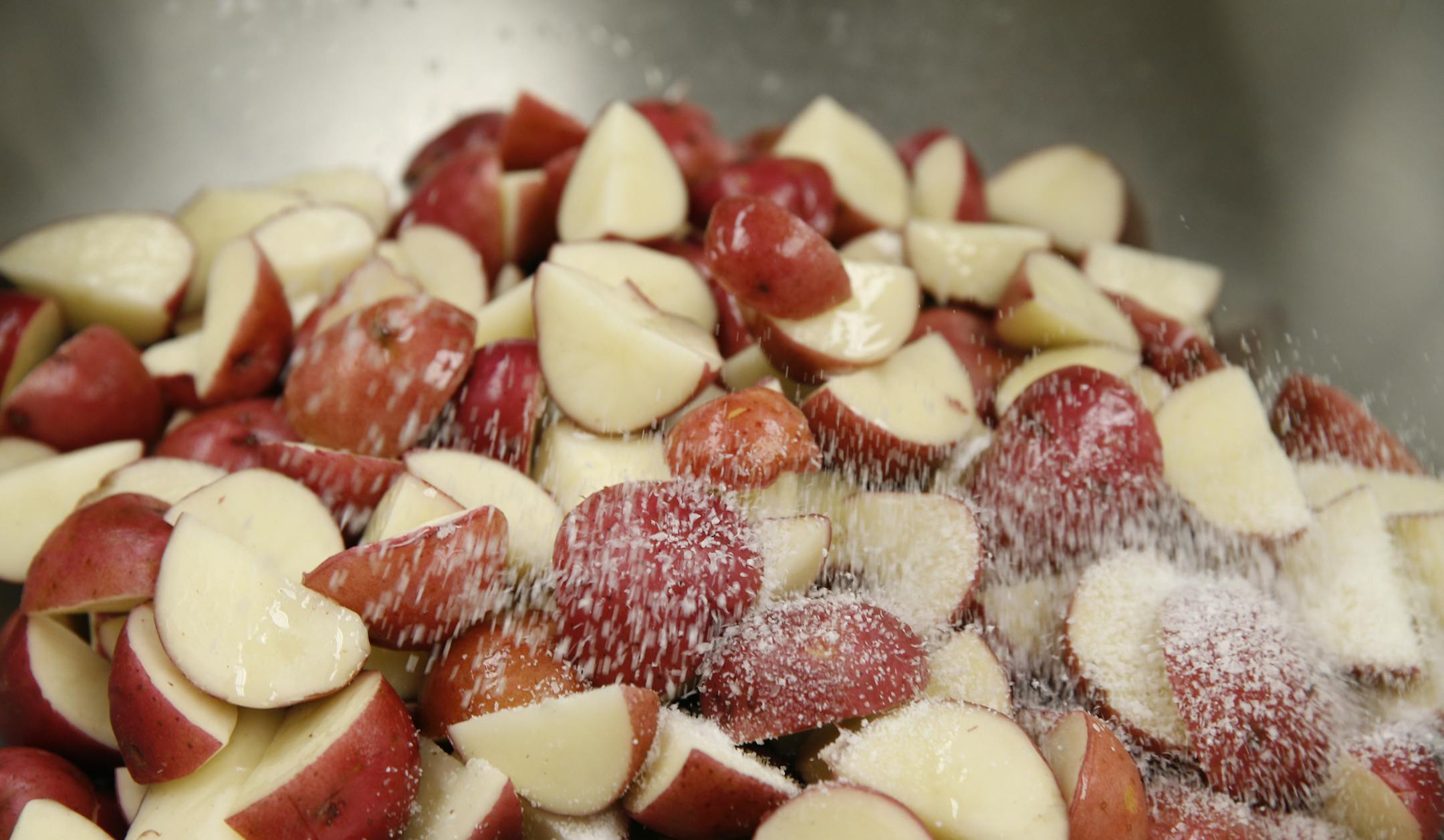 At the cafeteria of Washburn H.S., Fresh cut red potatoes are salted to be roasted as part of new approach of fresh and local ingredients on the student menu.]rtsong-taatarii@startribune.com