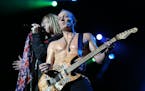 Def Leppard's Joe Elliott , left, and Phil Collen performed "Disintegrate" with the rest of the band. ]