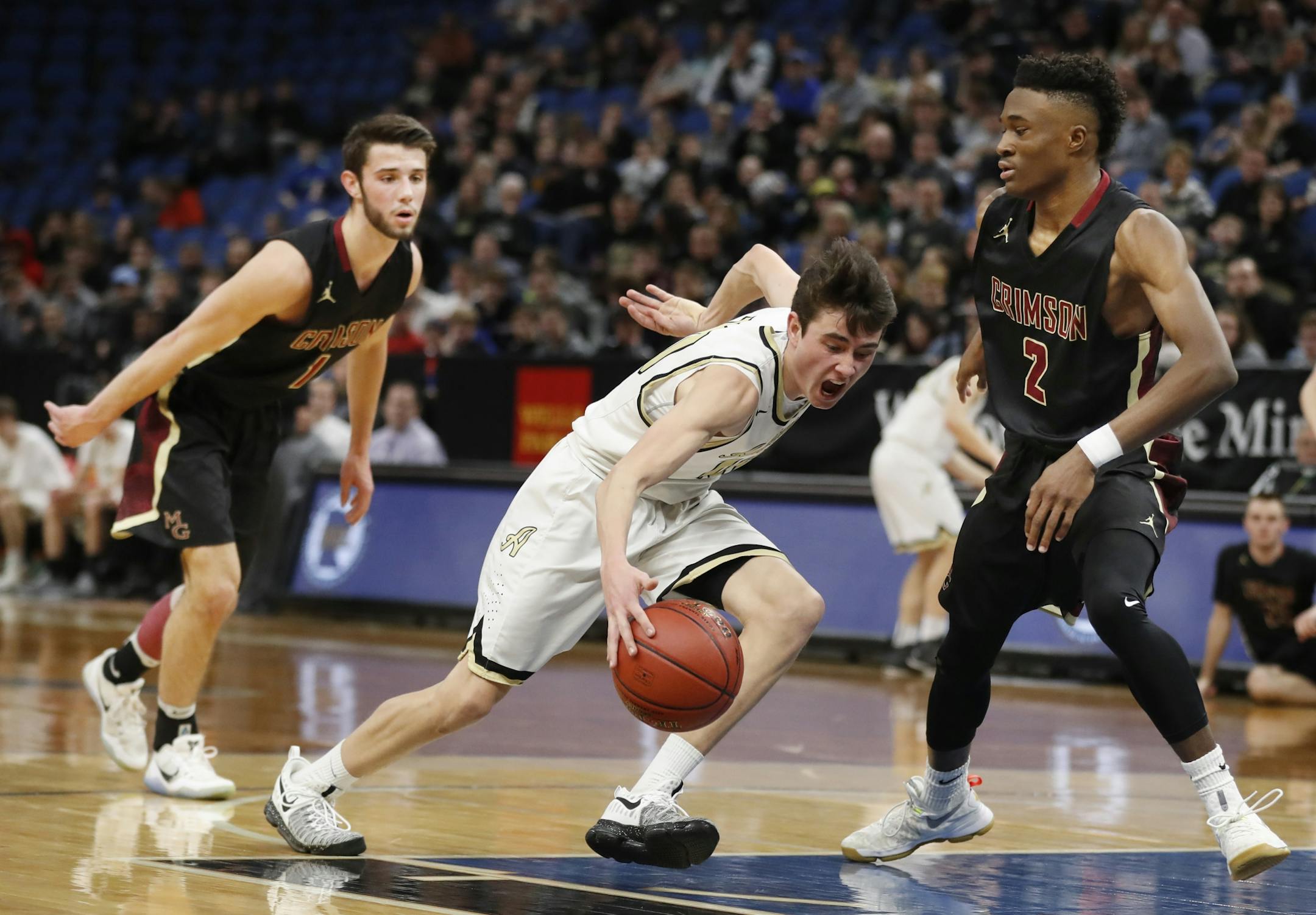 Conner Knoepfle left of Andover drove to the basket on Gare Ewefada of Maple Grove during quarterfinal class 4A basketball action at Target Center Wednesday March 22 ,2017 in Minneapolis, MN.