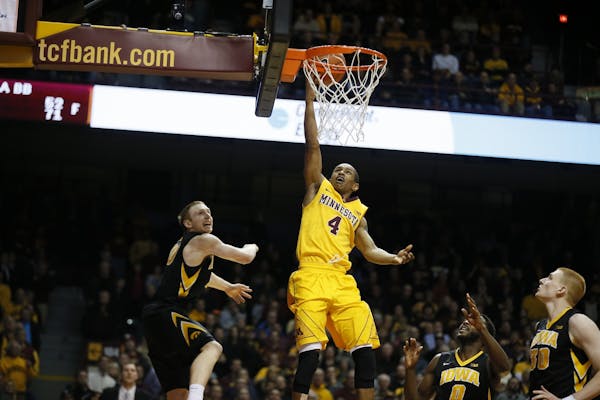 Minnesota Gophers guard DeAndre Mathieu (4) attempts his last-second shot on the Iowa defense. No time was left on the clock, and the Gophers lost 77-