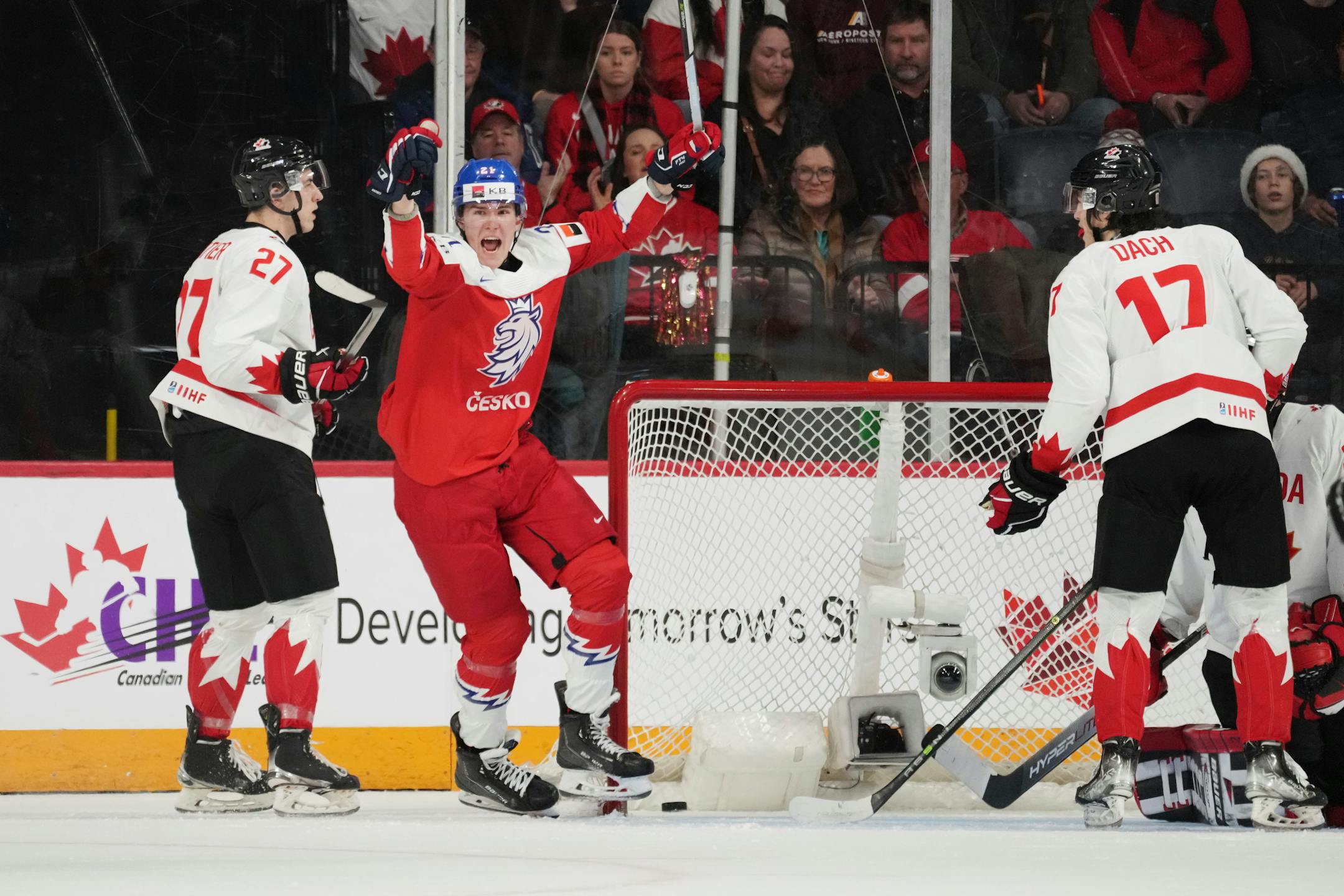 Czechia's Jaroslav Chmelar, center, celebrates after a goal in front of Canada's Jack Matier, left, and Colton Dach during second-period IIHF world junior hockey championship game action in Halifax, Nova Scotia, Monday, Dec. 26, 2022. (Darren Calabrese/The Canadian Press via AP)