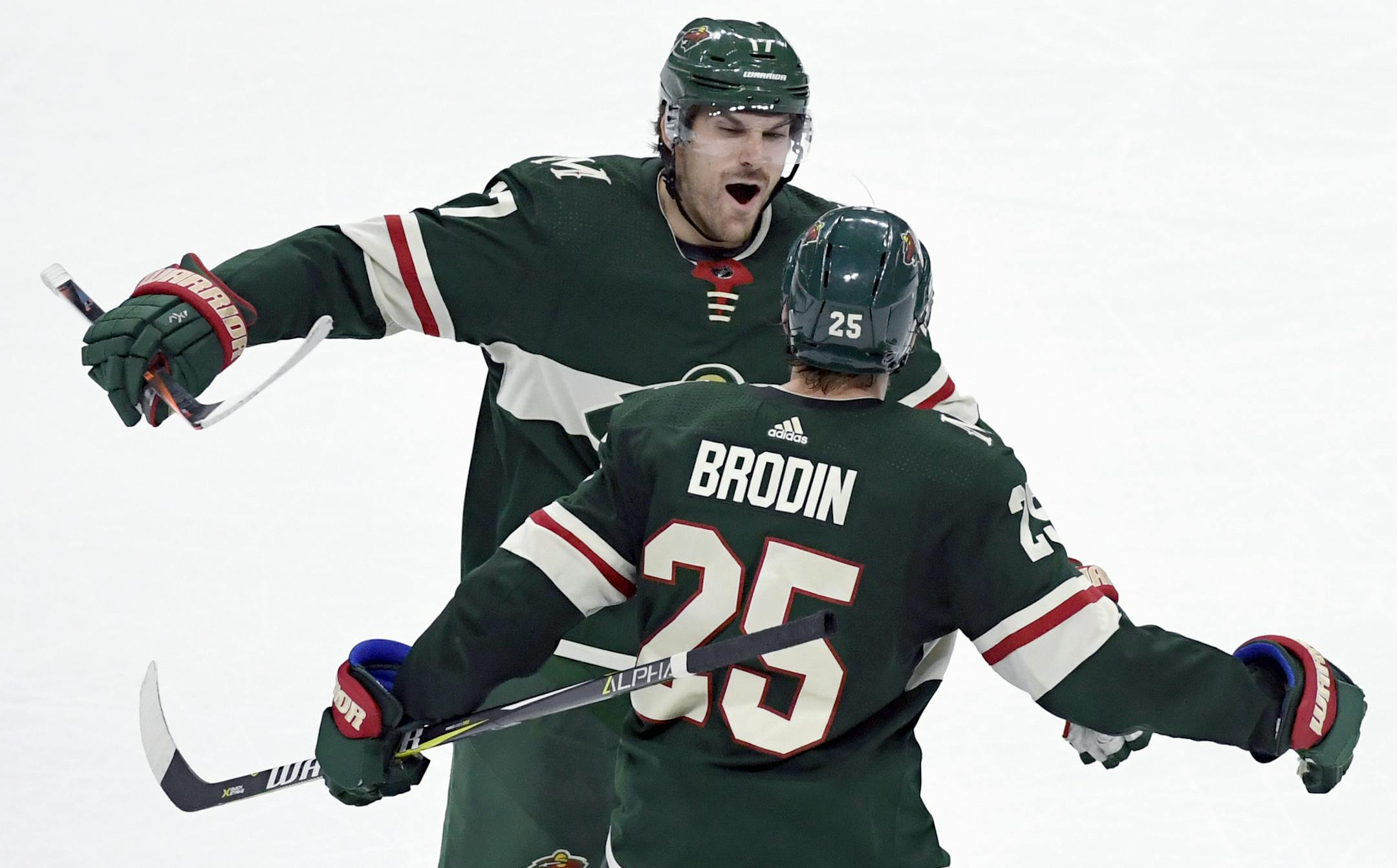 Minnesota Wild's Marcus Foligno (17) congratulates defenseman Jonas Brodin (25), of Sweden, on scoring a shorthanded empty net goal against the Colorado Avalanche during the third period of an NHL hockey game Saturday, Oct. 27, 2018, in St. Paul, Minn. The Wild won 3-2. (AP Photo/Hannah Foslien)
