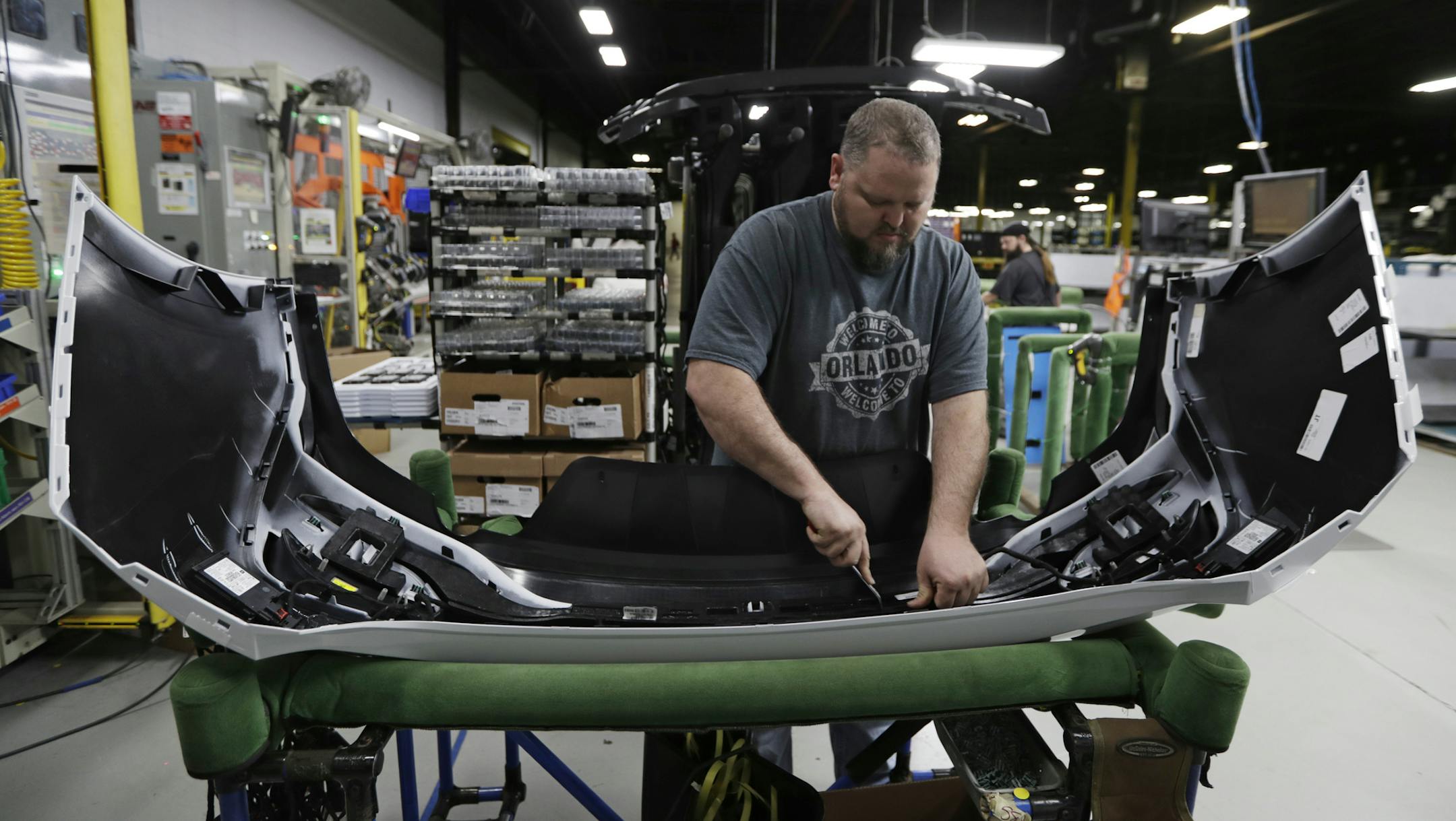 Machine operator Ed Lloyd works on the rear end of a General Motors Chevrolet Cruze at Jamestown Industries, Wednesday, Nov. 28, 2018, in Youngstown, Ohio. Jamestown Industries supplies parts for the Chevy Cruze. (AP Photo/Tony Dejak)