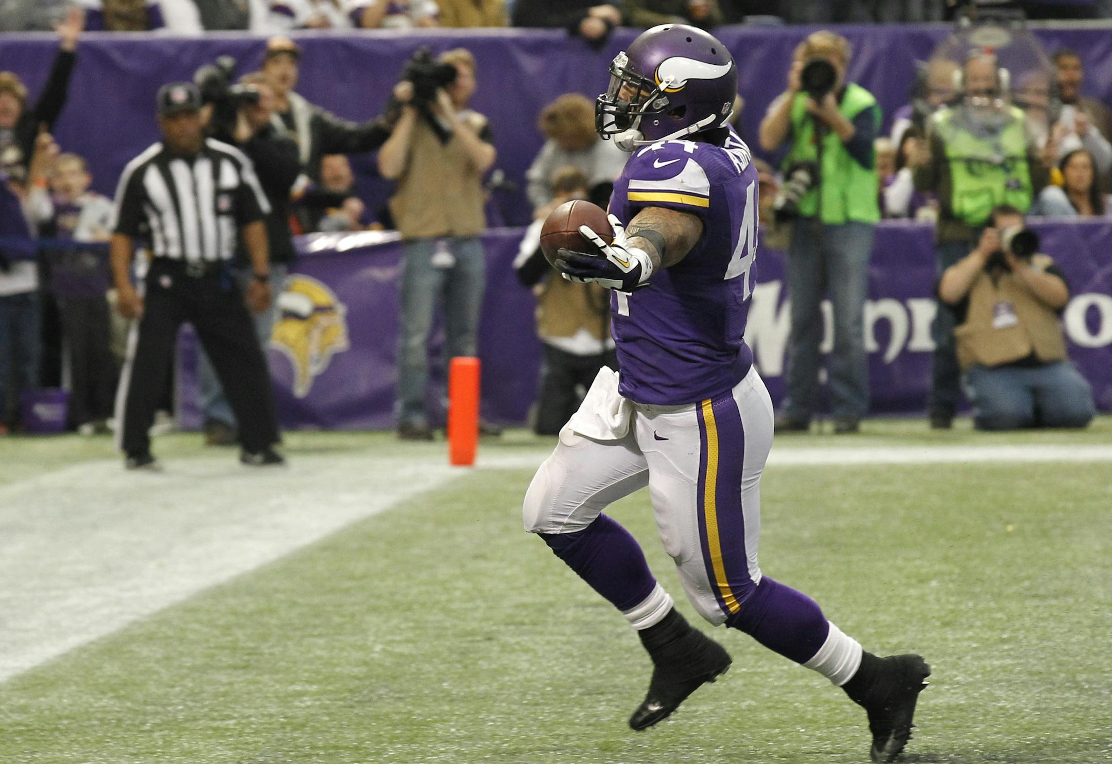 Minnesota Vikings running back Matt Asiata reacts after scoring on a 1-yard touchdown run during the second half of an NFL football game against the Philadelphia Eagles, Sunday, Dec. 15, 2013, in Minneapolis. (AP Photo/Ann Heisenfelt)