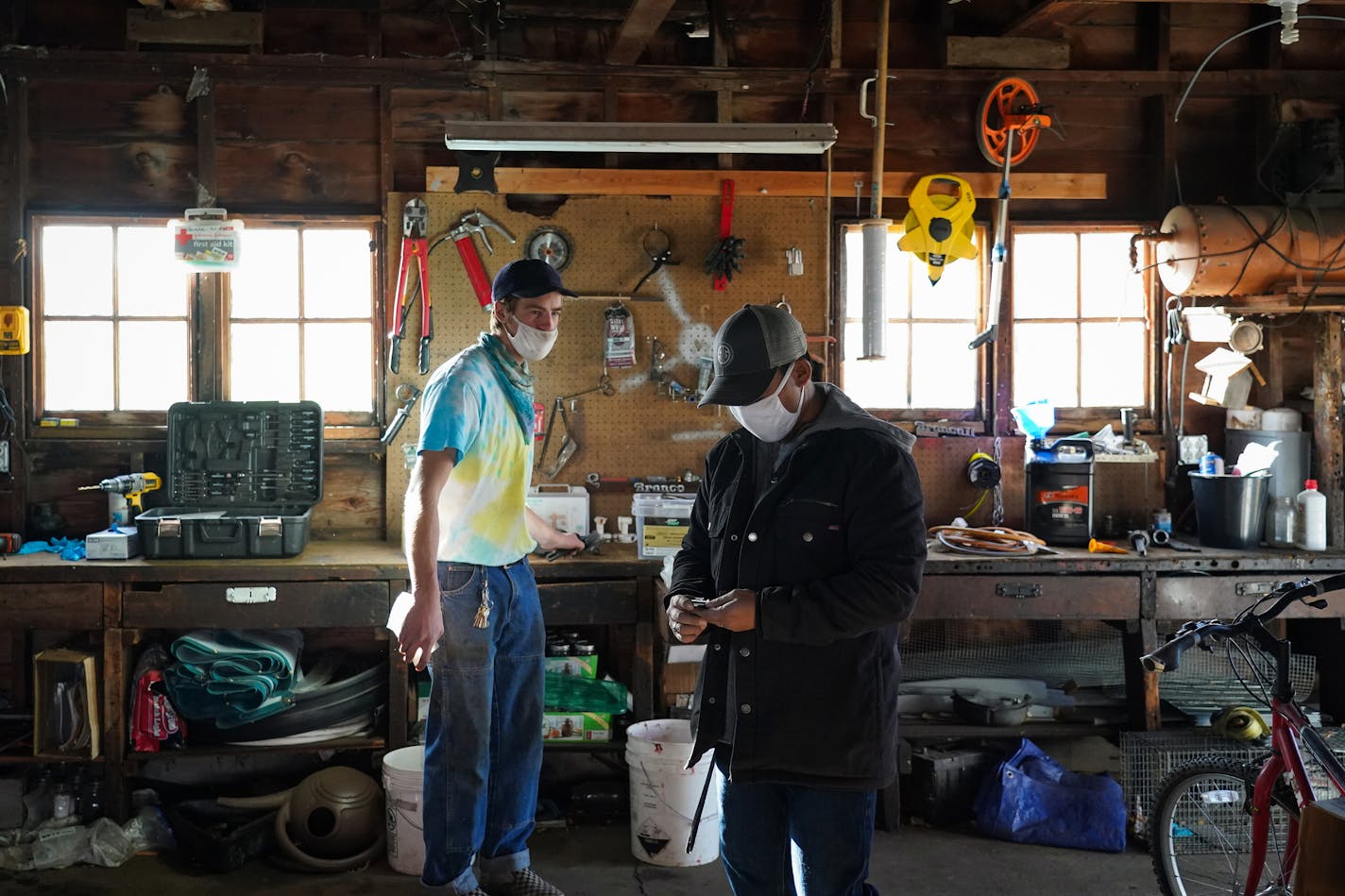 Farm hand Will Hartnett (left) and HAFA Farm manager Dao Yang looked for machinery parts as they prepped a brush cutter to be put away for the winter season. ] Shari L. Gross • shari.gross@startribune.com Although the crops have all been harvested, several employees of HAFA Farms were busy on the property getting ready for winter. A cooperative of Hmong American farmers can now buy the 155 acre property in rural Dakota County that they've farmed since 2014 thanks to $2M in the state bonding bill