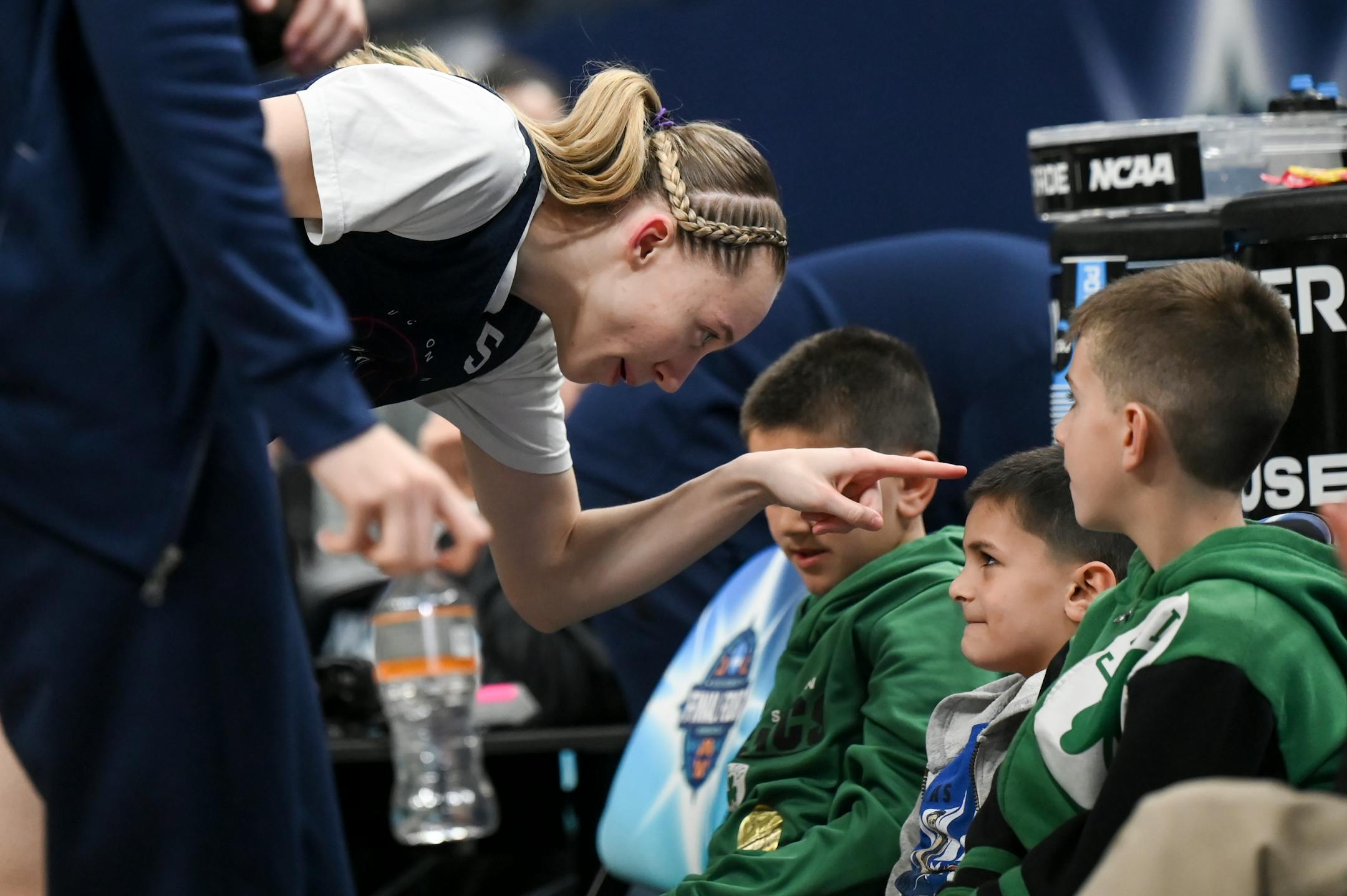 UConn guard Paige Bueckers (5) interacts with a group of children on the team's bench during a Final Four open practice held Saturday, April 2, 2022 at Target Center in Minneapolis, Minn.