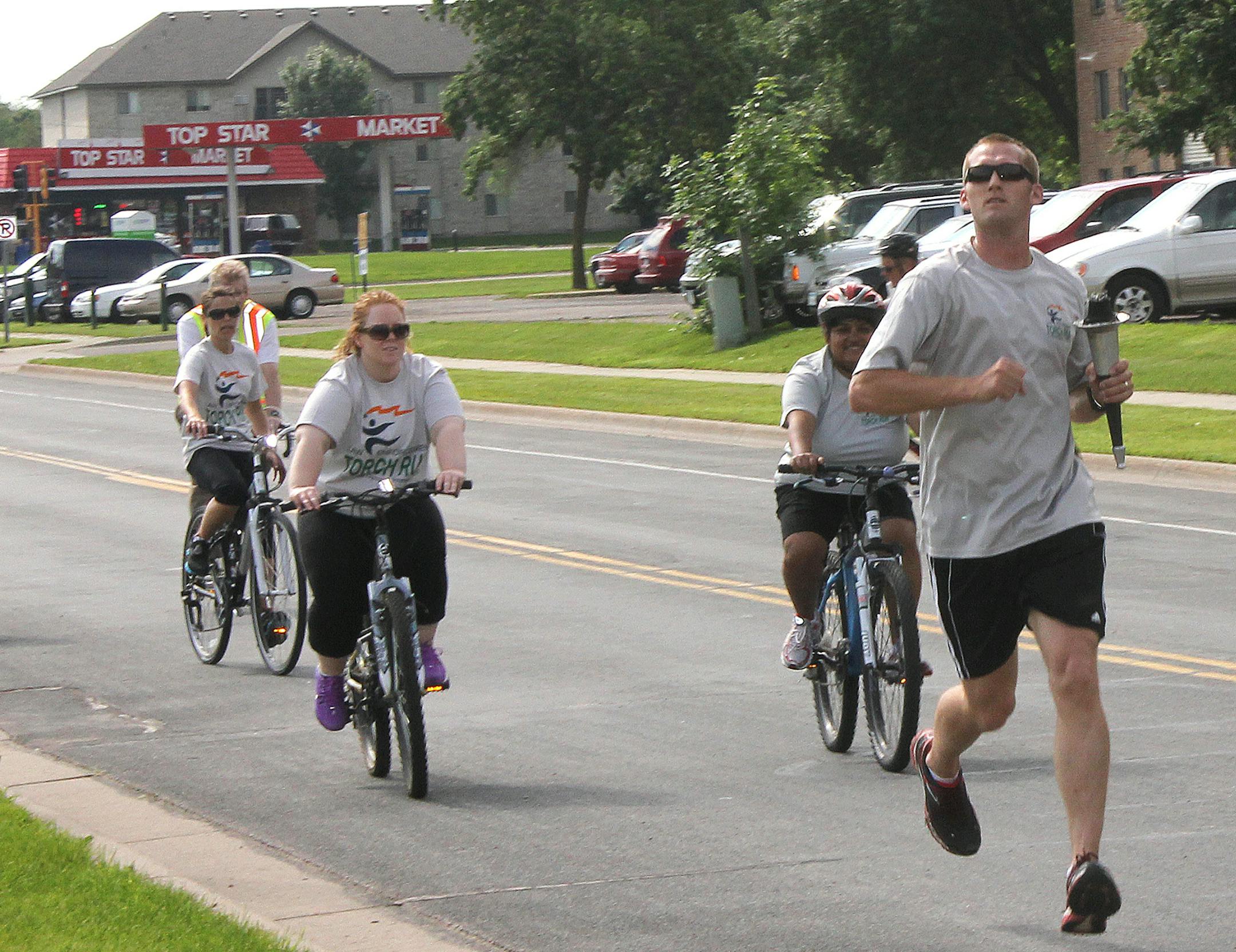 Runners and bicyclists participate in the 2013 Torch Run, which benefits Special Olympics. This year, the Police Department is opening up the event for public participation.‚Äã City of Shakopee