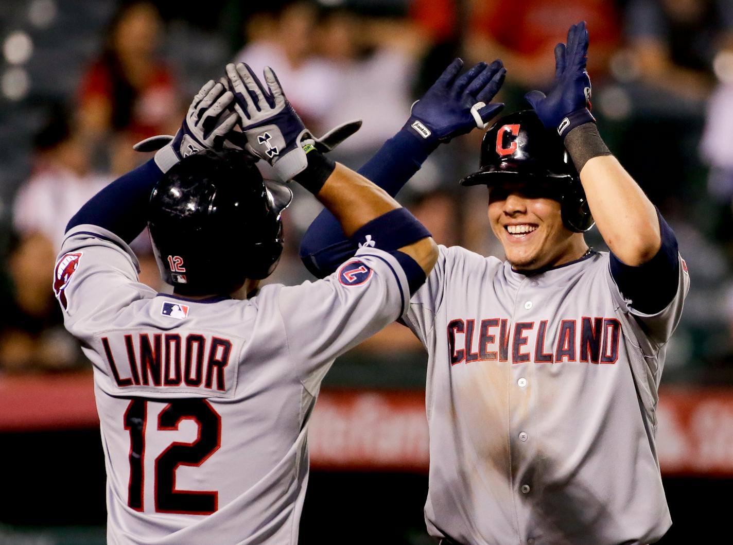 Cleveland Indians' Giovanny Urshela, right, celebrates after a two-run home run with Francisco Lindor against the Los Angeles Angels during the 12th inning of a baseball game in Anaheim, Calif., Tuesday, Aug. 4, 2015. (AP Photo/Chris Carlson)