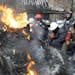 Protesters on Tuesday rested behind a barricade in front of riot police in Kiev, Ukraine. The government&#x2019;s concessions are unlikely to defuse t