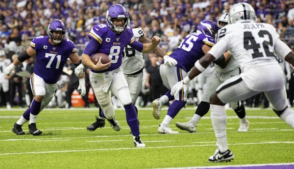Minnesota Vikings quarterback Kirk Cousins (8) scrambled in the second quarter.
