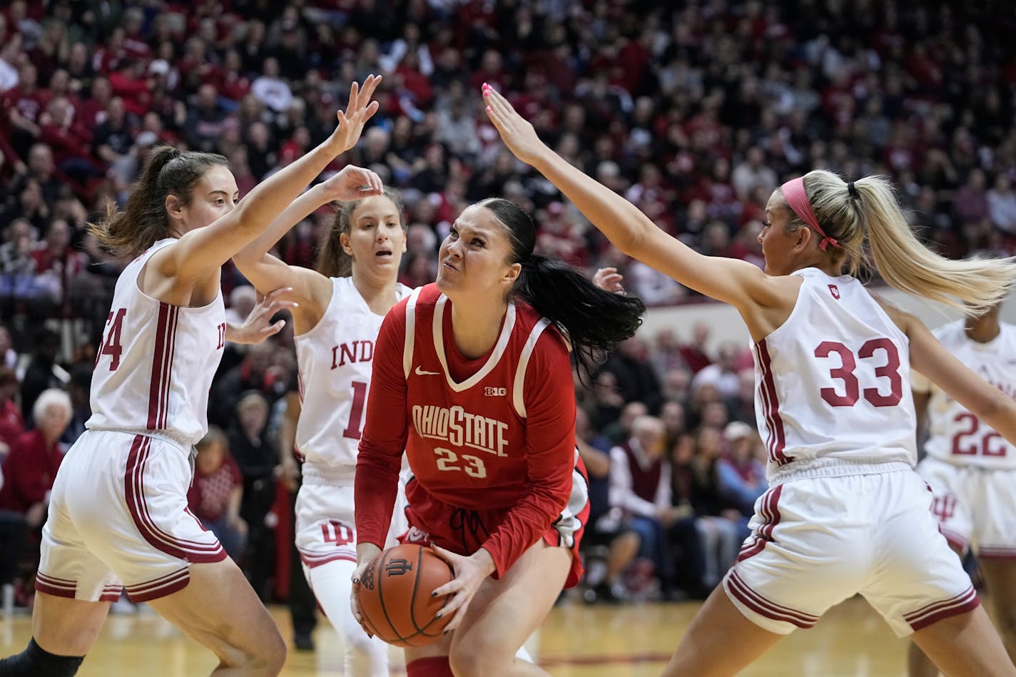 Ohio State's Rebeka Mikulasikova (23) goes to the basket against Indiana's Mackenzie Holmes (54) and Sydney Parrish (33) during the first half of an NCAA college basketball game Thursday, Jan. 26, 2023, in Bloomington, Ind. (AP Photo/Darron Cummings)