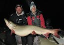 Nolan Sprengeler, left, and Kevin Kray with the massive fish. The 57 3/4-inch muskie had a girth of 29 inches.
