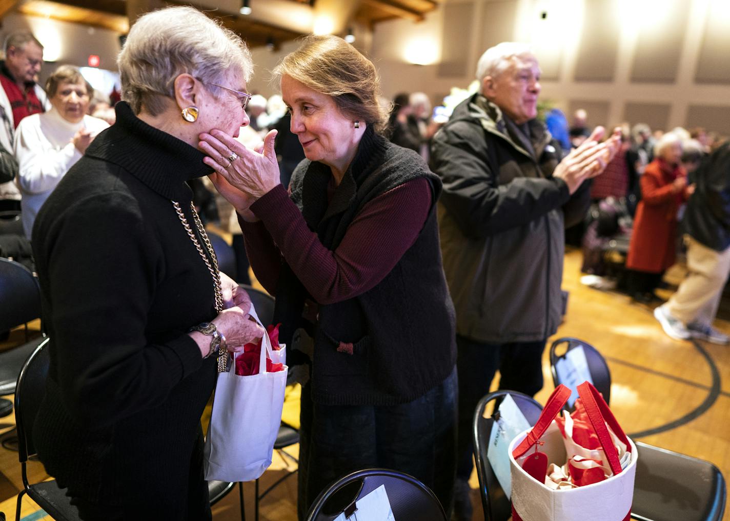 Lisa Kupcho, right, embraced friend Polly Posten after mass at St. Joan of Arc Church in Minneapolis. Kupcho travels 20 miles from Chanhassen to attend services there.