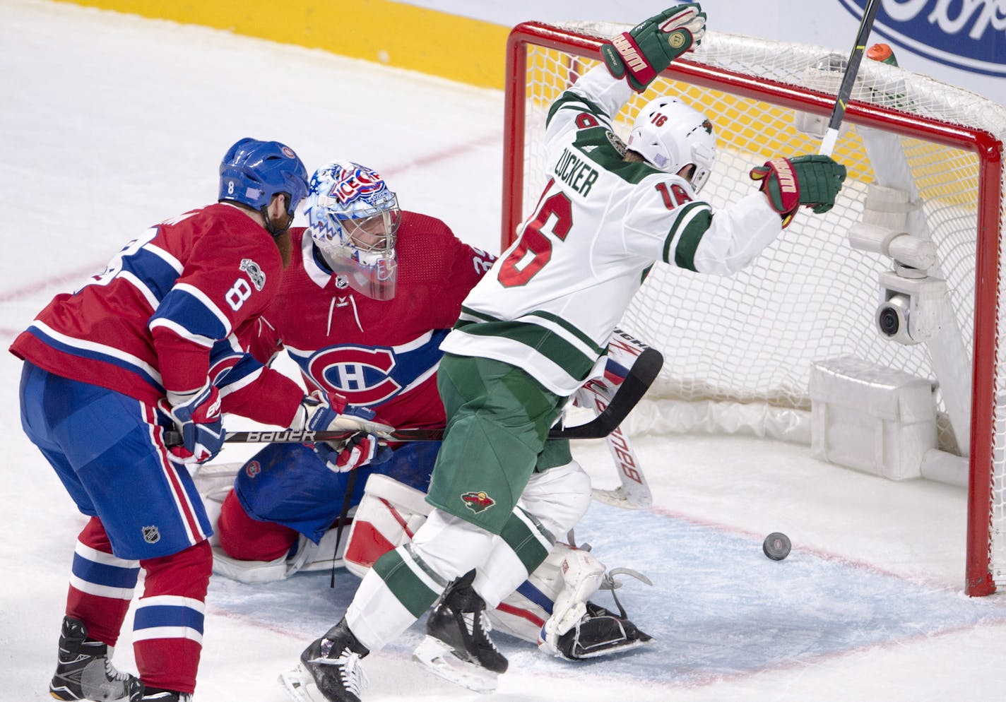 Minnesota Wild left wing Jason Zucker (16) celebrates after scoring as Montreal Canadiens goalie Charlie Lindgren (39) and defenseman Jordie Benn (8) watch during the third period of an NHL hockey game Thursday, Nov. 9, 2017, in Montreal. (Ryan Remiorz/The Canadian Press via AP)