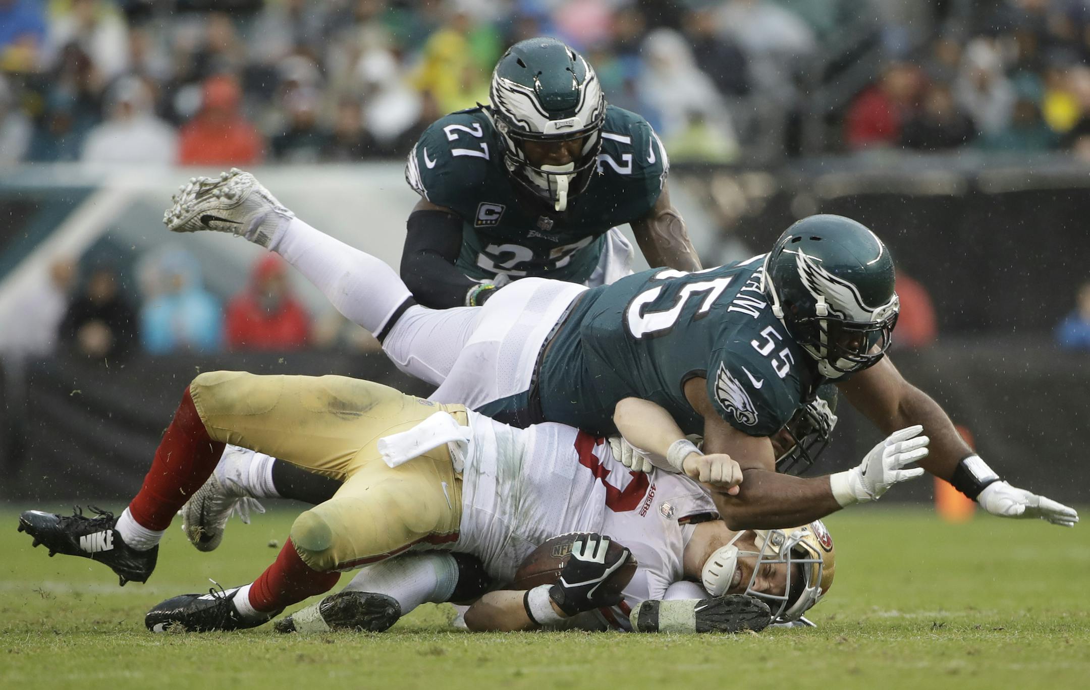 San Francisco 49ers' C.J. Beathard (3) is sacked by Philadelphia Eagles' Brandon Graham (55) and Mychal Kendricks (95) as Malcolm Jenkins (27) looks on during the second half of an NFL football game, Sunday, Oct. 29, 2017, in Philadelphia,. (AP Photo/Michael Perez) ORG XMIT: NYOTK