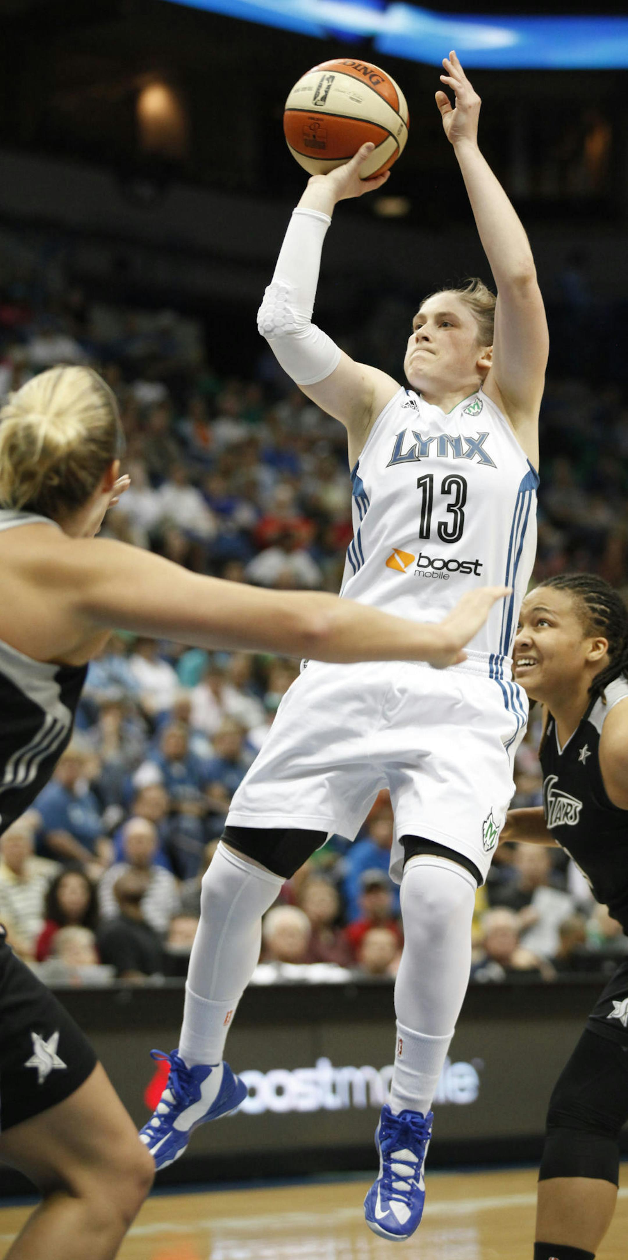 Minnesota Lynx guard Lindsay Whalen (13) goes up for a shot against San Antonio Silver Stars center Jayne Appel, left, in the first half of a WNBA basketball game, Friday, August 2, 2013, in Minneapolis. (AP Photo/Stacy Bengs)