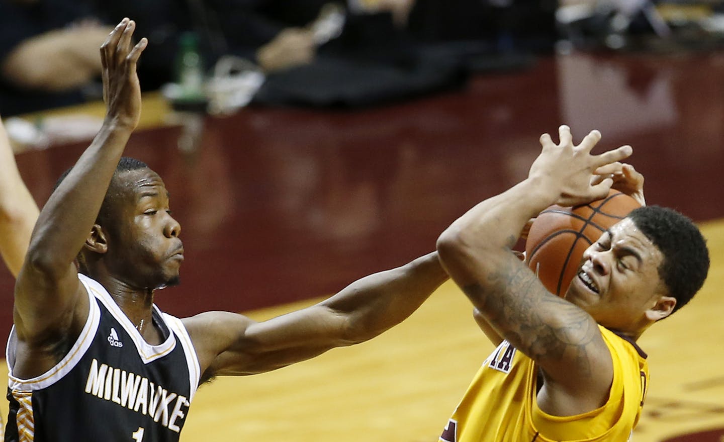 Nate Mason (2) was defended by Jordan Johnson (1) in the first half.