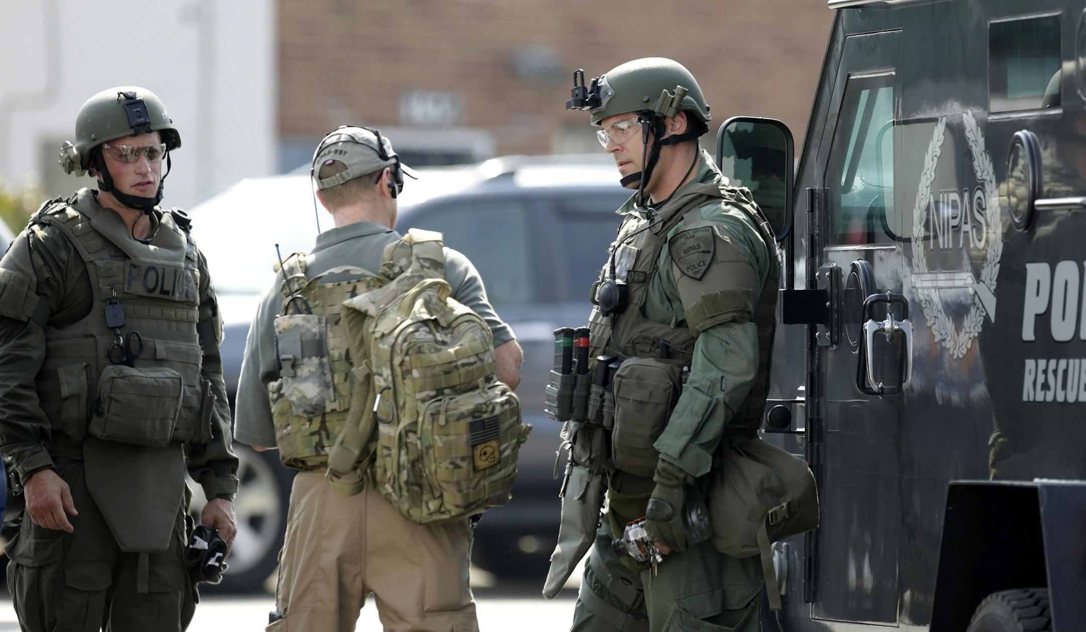 Police officers meet up before heading out for a manhunt on Tuesday, September 1, 2015 in Fox Lake, Ill. (Stacey Wescott/Chicago Tribune/TNS)