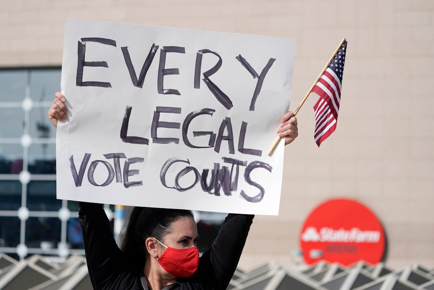 Supports of President Donald Trump holds signs during a demonstration outside the State Farm Arena where Fulton County has a voting counting operation, Thursday, Nov. 5, 2020, in Atlanta. (AP Photo/John Bazemore)