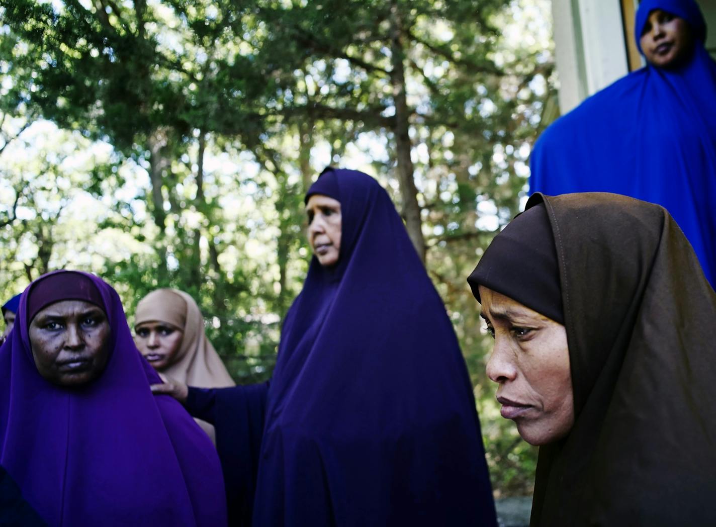 In Wilmar, far right, Lul Mohamed grieved for her son Ahmed Ashi, 11 who drowned along with childhood friend Idris Hussein,11, at nearby Foot Lake near the dock. [ Richard Tsong-Taatarii/rtsong-taatarii@startribune.com