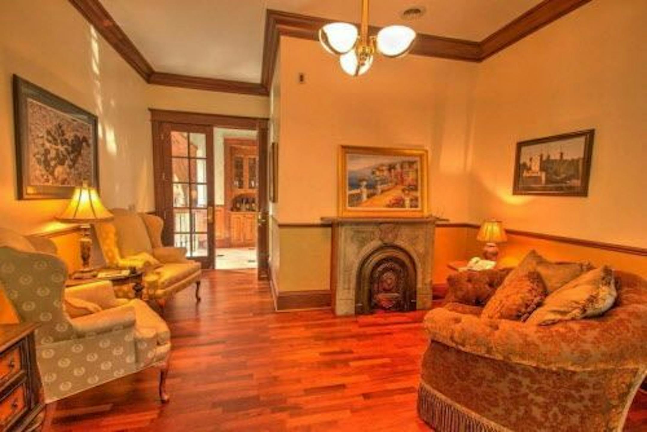 A sitting room with one of nine fireplaces in the home.