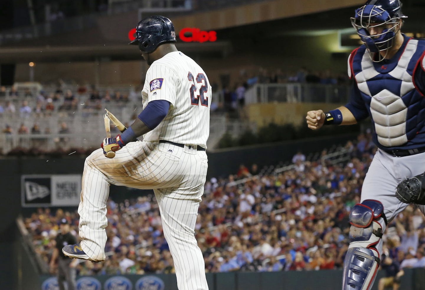 Atlanta Braves catcher A.J. Pierzynski, right, pumps his fist as Minnesota Twins' Miguel Sano, left, breaks his bat over his leg after striking out to end the eighth inning of a baseball game Wednesday, July 27, 2016, in Minneapolis. The Braves won 9-7. (AP Photo/Jim Mone)