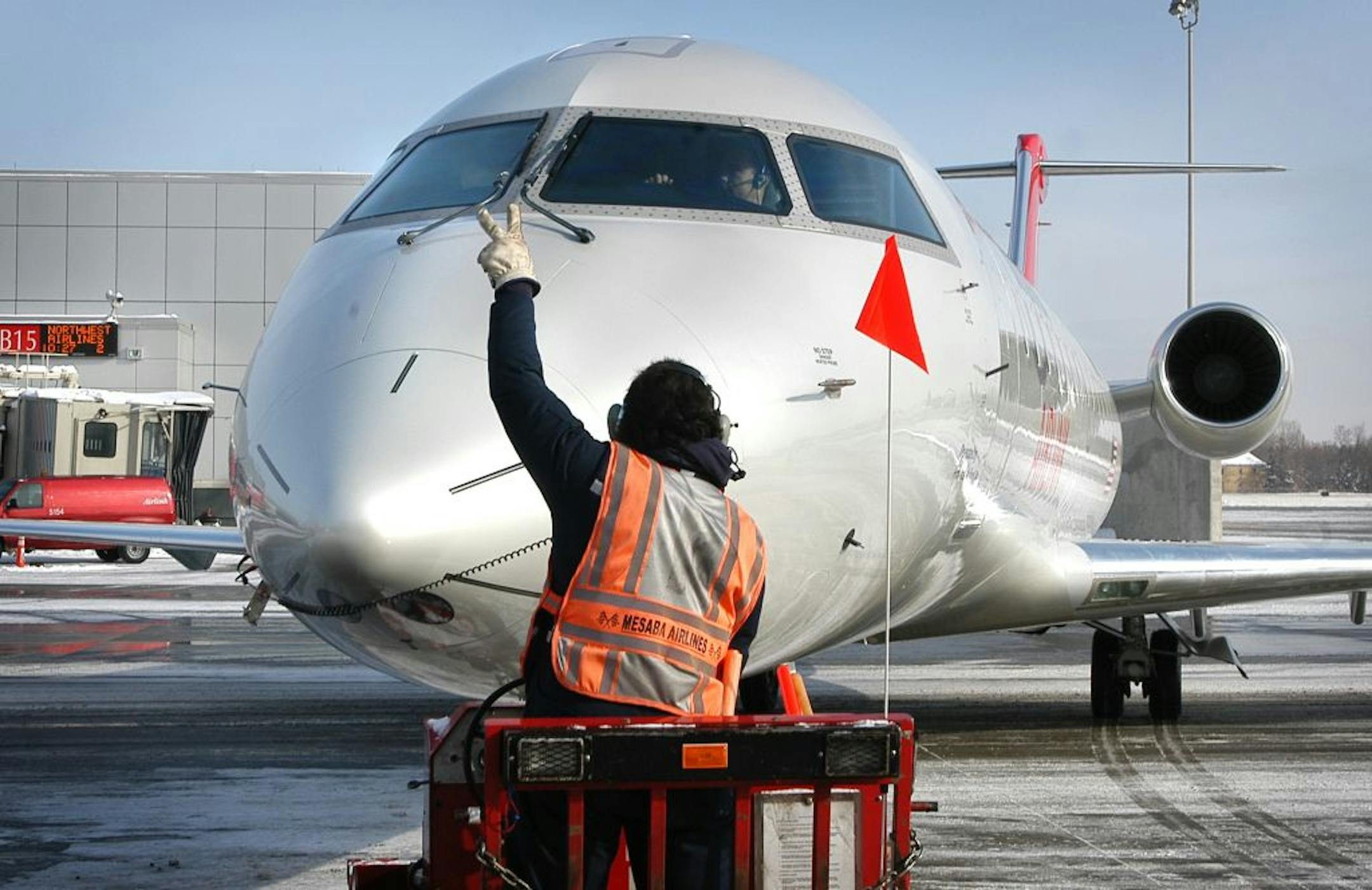 Photo: Airplane being guided to gate.