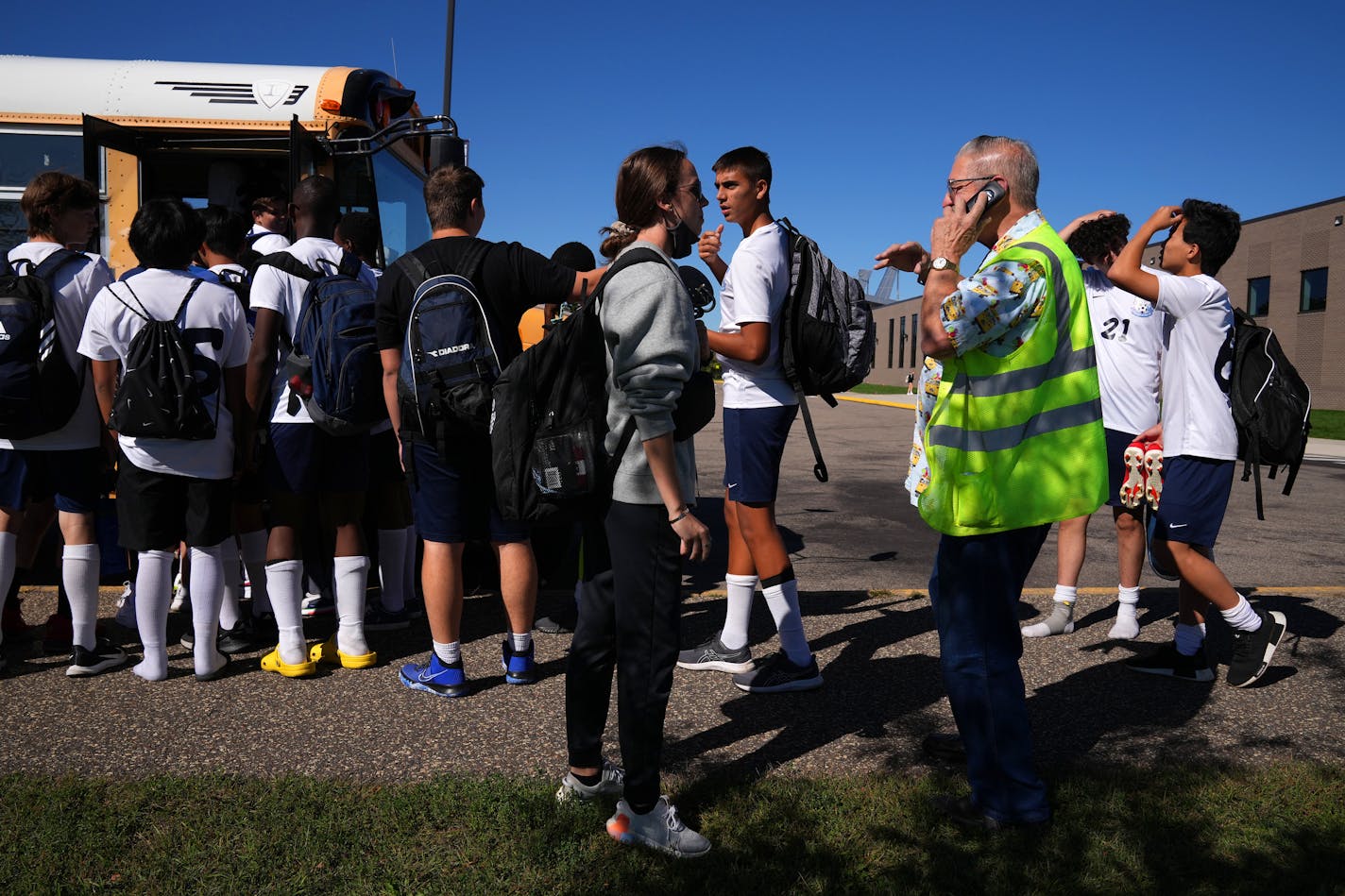 Bus driver Axel Gessell spoke on the phone to his bus company as both the Blaine freshmen boys and girls soccer teams boarded the same bus to go to two different schools for their away matches because of a lack of transportation Friday. ] ANTHONY SOUFFLE • anthony.souffle@startribune.com