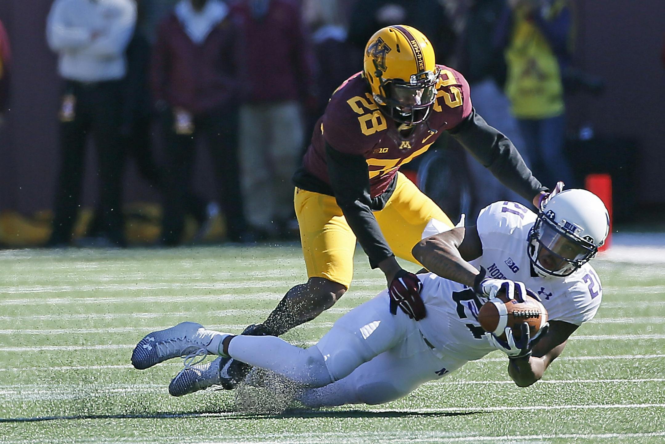 Gophers defensive back Jalen Myrick (28) stopped Northwestern's wide receiver Kyle Prater (21) after he made a catch in the second quarter as the Minnesota Gophers took on the Northwestern Wildcats at TCF Stadium, Saturday, October 11, 2014 in Minneapolis, MN.