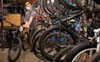 Braeden Cox, a service technician at Ski Hut, rolled out a finished bike to return to a customer on Thursday. As with other retailers in the outdoors,