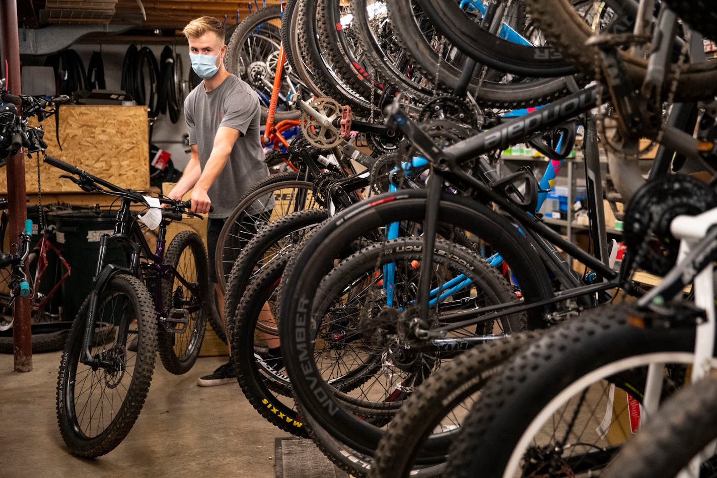 Braeden Cox, a service technician at Ski Hut, rolled out a finished bike to return to a customer on Thursday. As with other retailers in the outdoors, Minnesota bike sellers went from wondering if they'd make another sale during the pandemic to having consumers clear out their inventory.