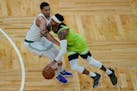 Timberwolves guard D'Angelo Russell drives against Boston forward Grant Williams