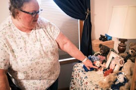 Nancy Gag Braun points to a small urn holding the ashes of her late husband Steve Braun, in her Mankato, Minn., bedroom on May 13, 2024. After caring 