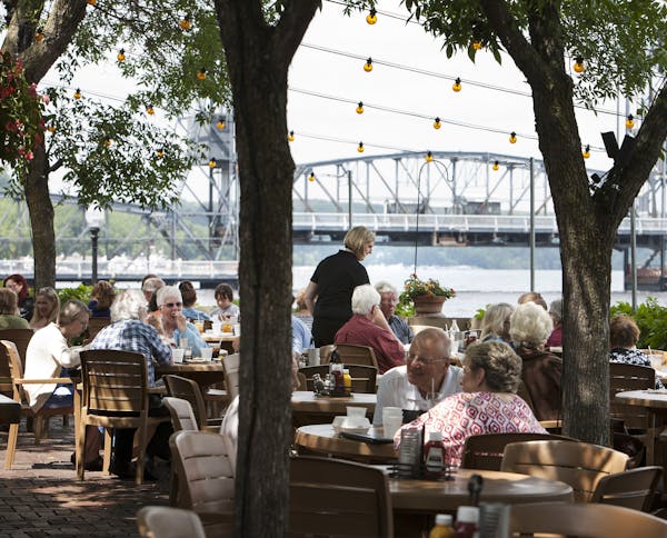 Guests dine on the patio overlooking the St. Croix River at Dock Cafe in Stillwater June 26, 2014. (Courtney Perry/Special to the Star Tribune)