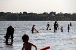 Swimmers enjoy the water at Lake Nokomis Beach — which remains open — in 2017.