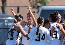 Prior Lake lacrosse players celebrate their sudden-death victory over Benilde-St. Margaret's in Thursday's girls state tournament semifinal.