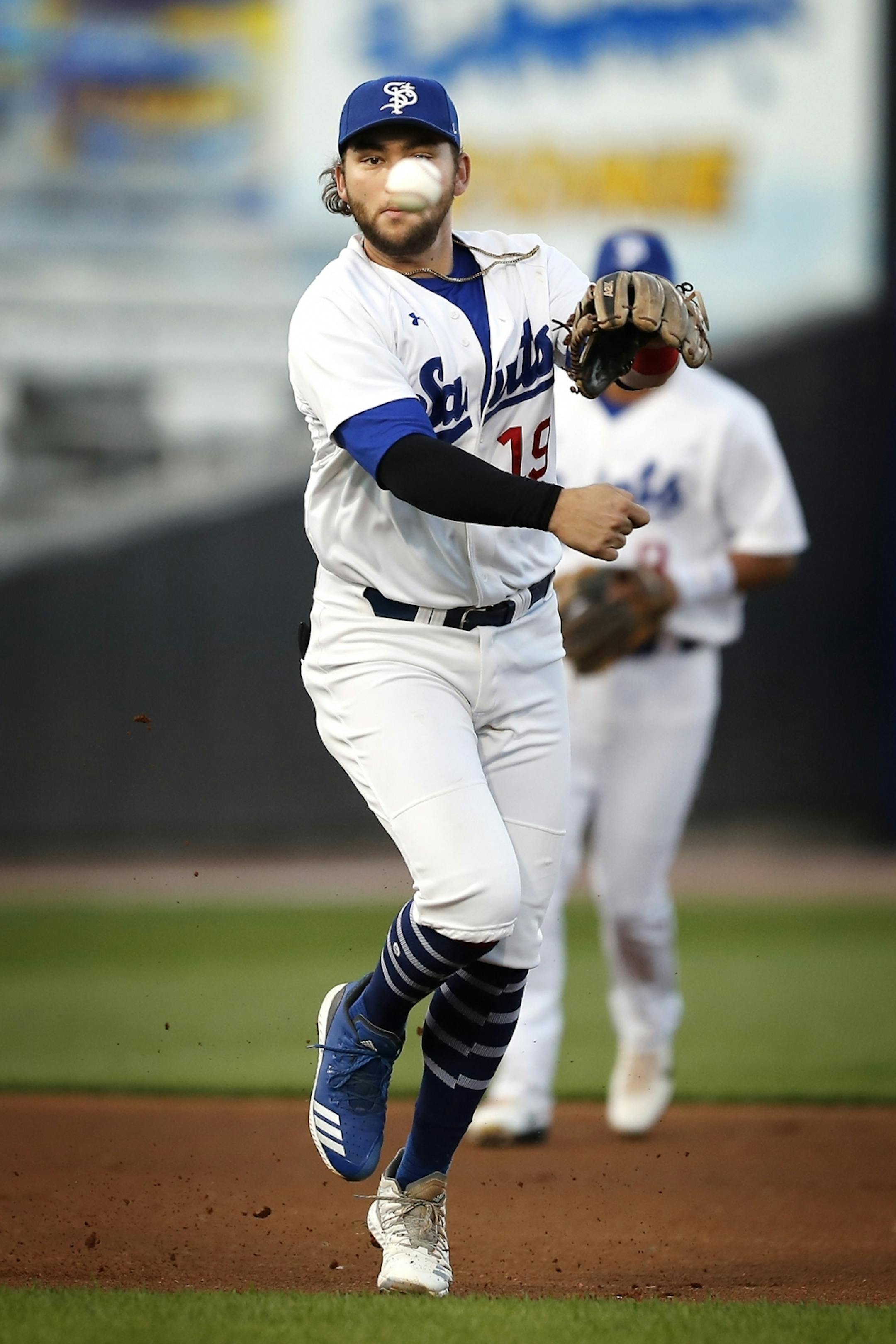 Saint Paul Saints third baseman Dante Bichette Jr. throws for an out at first base.