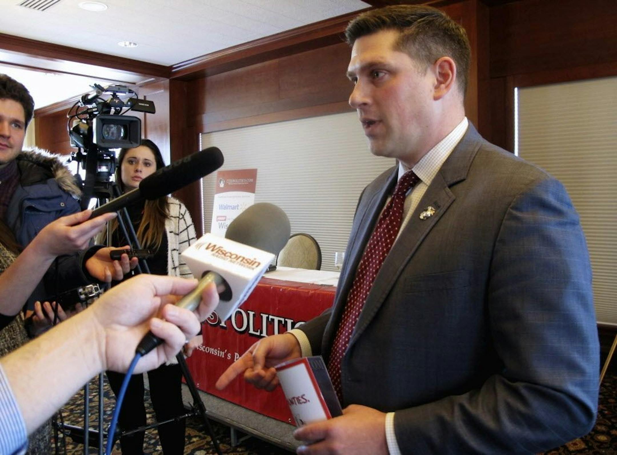 FILE - In this Jan. 30, 2018, file photo, Wisconsin Republican Senate candidate Kevin Nicholson speaks with reporters in Madison, Wis. Federal records show that Nicholson's parents have donated the maximum amount to the campaign of their son's Democratic rival, Sen. Tammy Baldwin. Nicholson is in a primary battle against Republican state Sen. Leah Vukmir, with the winner advancing to take on Baldwin in the fall.