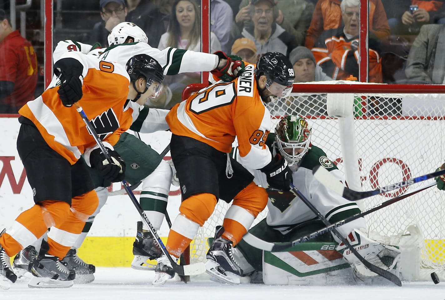 Philadelphia Flyers' Sam Gagner, center, scores a goal against Minnesota Wild's Devan Dubnyk, right, as Brayden Schenn trails during the first period of an NHL hockey game, Thursday, Feb. 25, 2016, in Philadelphia. (AP Photo/Matt Slocum)