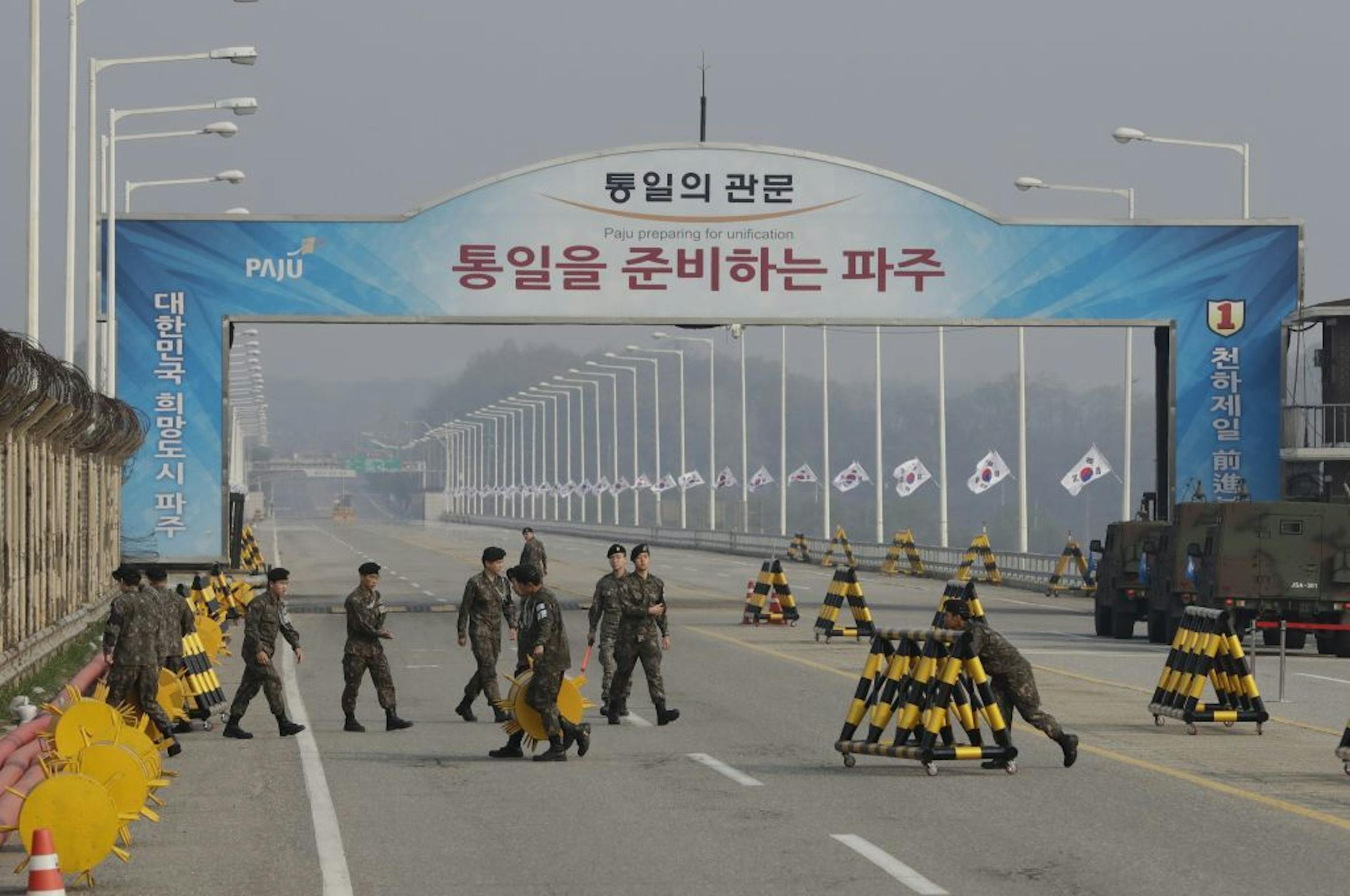 South Korean soldiers adjust barricades before the arrival of a motorcade carrying South Korean President Moon Jae-in at the Unification Bridge, which leads to the Panmunjom in the Demilitarized Zone, in Paju, South Korea, Friday, April 27, 2018. Moon and North Korean leader Kim Jong Un will meet at the southern side of the Panmunjom later in the day.