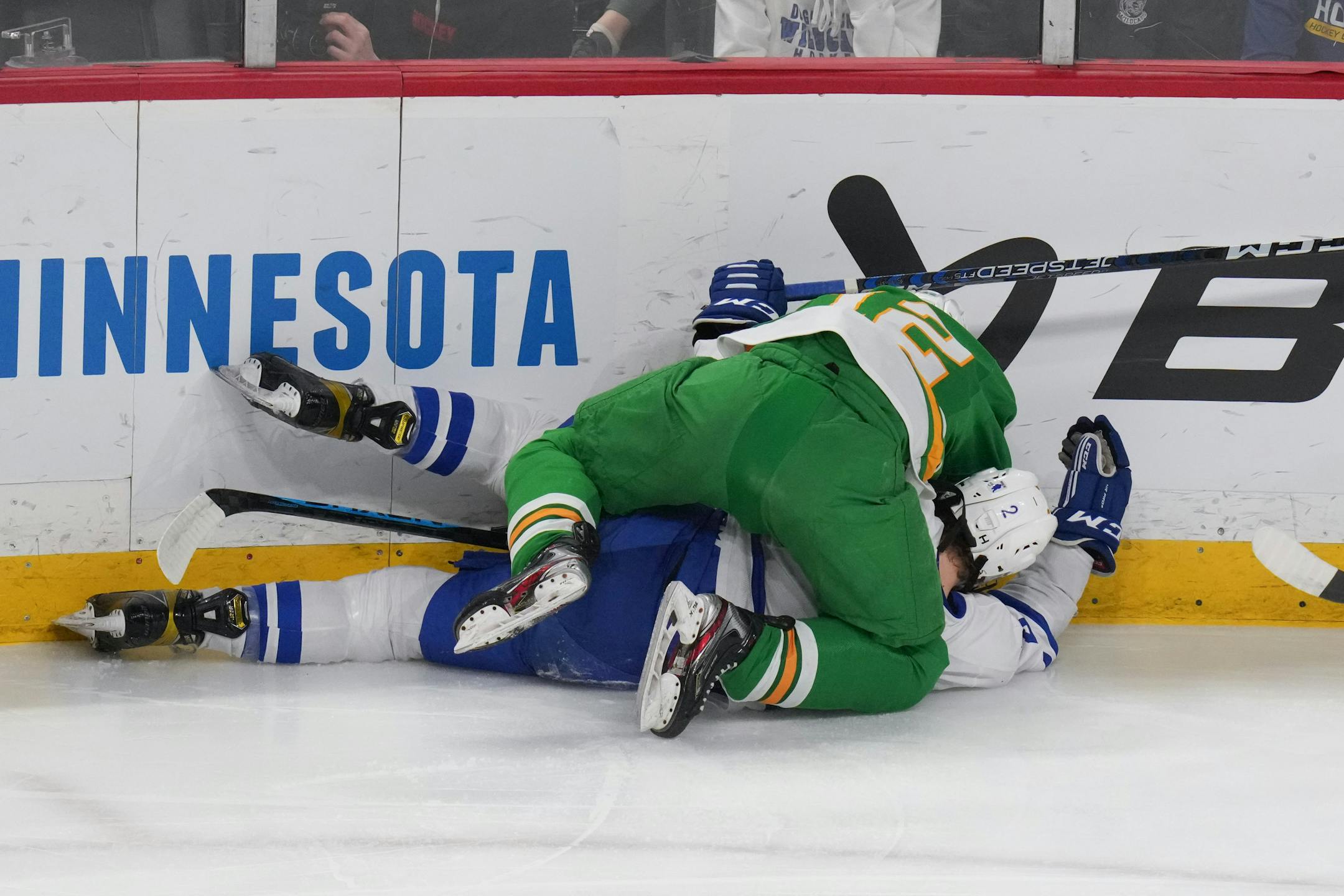 Minnetonka defenseman Ryan Holzer (2) and Edina forward Lucas Cole (12) hit the boards in the first period.