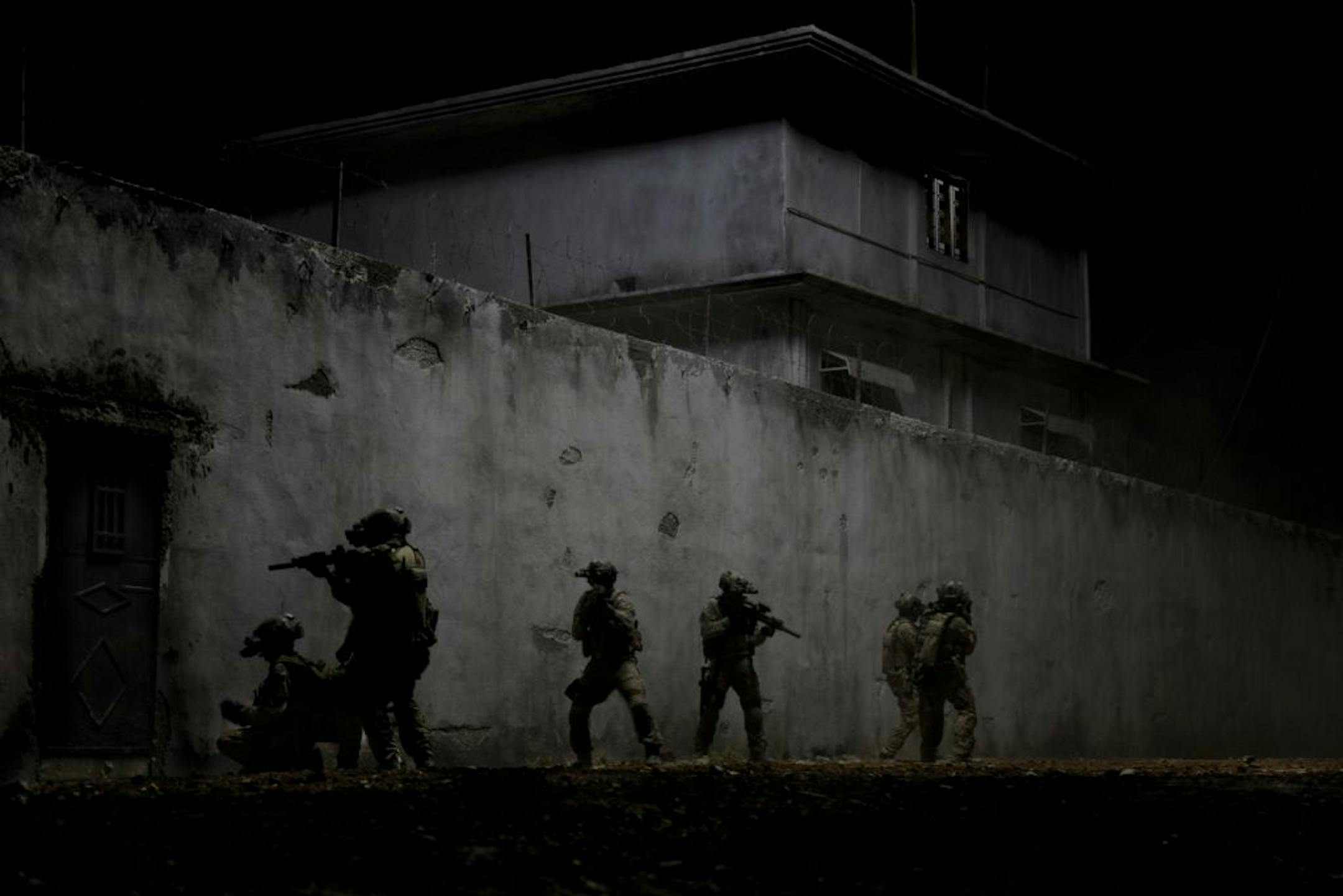 This publicity image provided by Columbia shows Navy SEALs raiding bin Laden's compound in "Zero Dark Thirty."