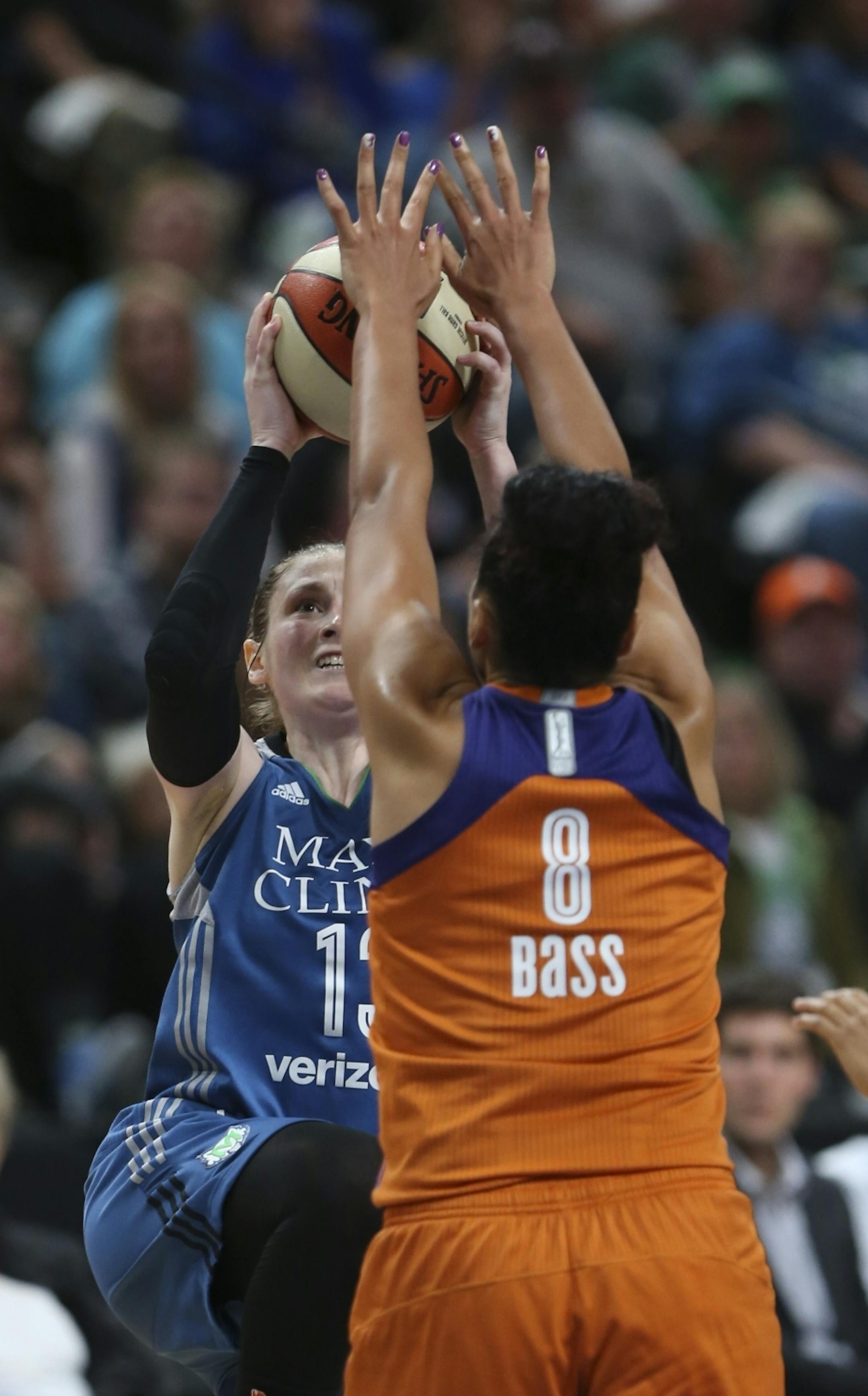 Minnesota Lynx guard Lindsay Whalen (13) took a shot despite the defense of Phoenix Mercury forward Mistie Bass (8) in the third quarter.