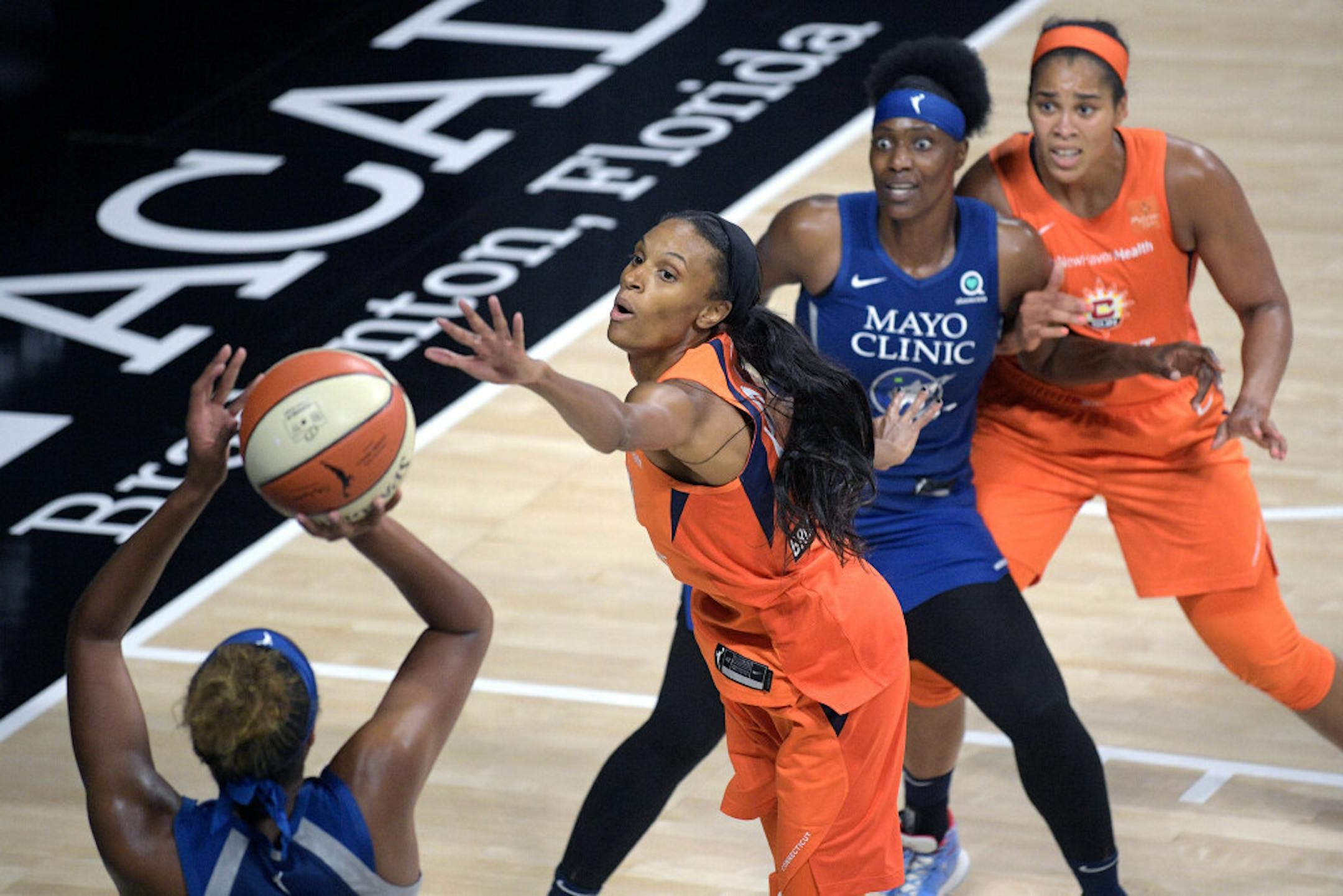 Connecticut Sun forward DeWanna Bonner, second from left, and center Brionna Jones, right, defend as Minnesota Lynx forward Napheesa Collier, left, goes up for a shot and center Sylvia Fowles watches during the second half.